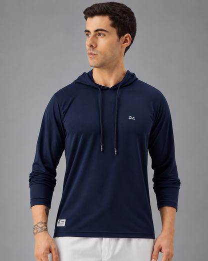 A man wearing a dark navy long-sleeve athletic hoodie with a small white logo on the left chest, photographed against a plain white background.